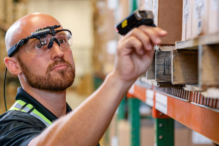 A warehouse worker using smart glasses