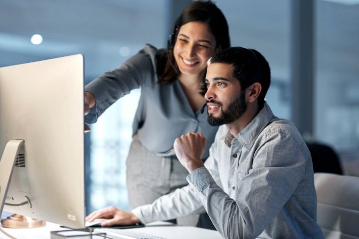 Two employees using a computer