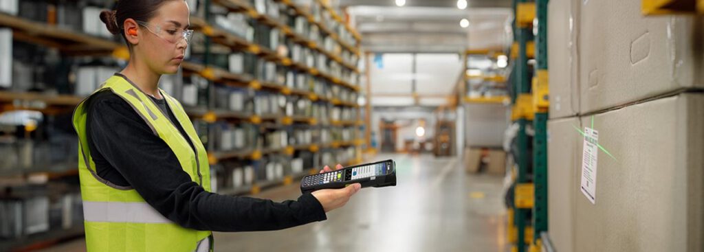 Warehouse worker using Zebra MC3400 to scan barcode in warehouse
